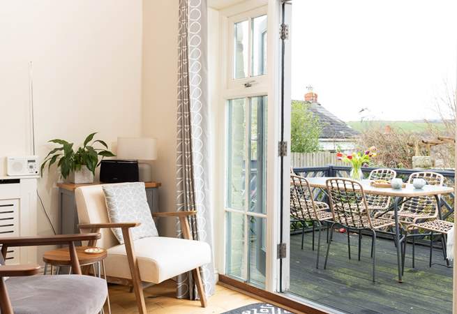 Open the doors from the kitchen/dining-room onto the terrace to bring the outside in.