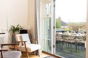 Open the doors from the kitchen/dining-room onto the terrace to bring the outside in.