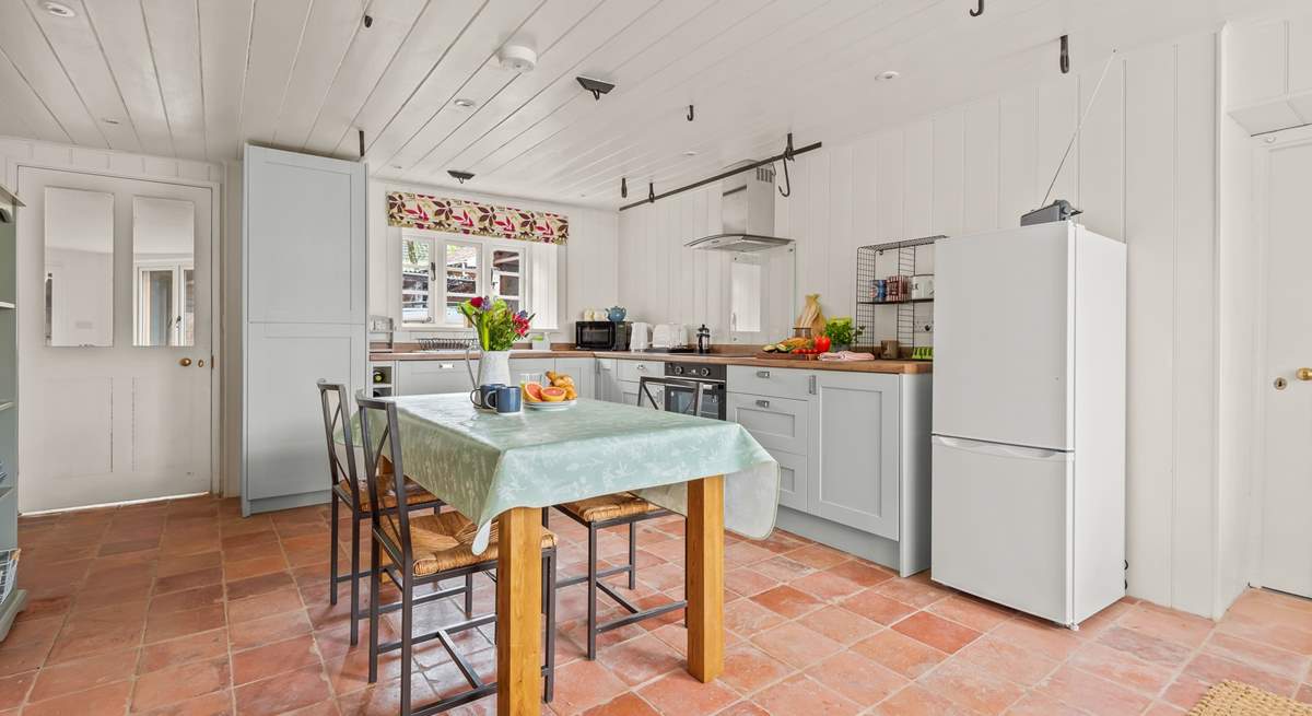 The kitchen also leads into the sun-trap of a conservatory via the door to the left, and into the dining-room via the door to the right.