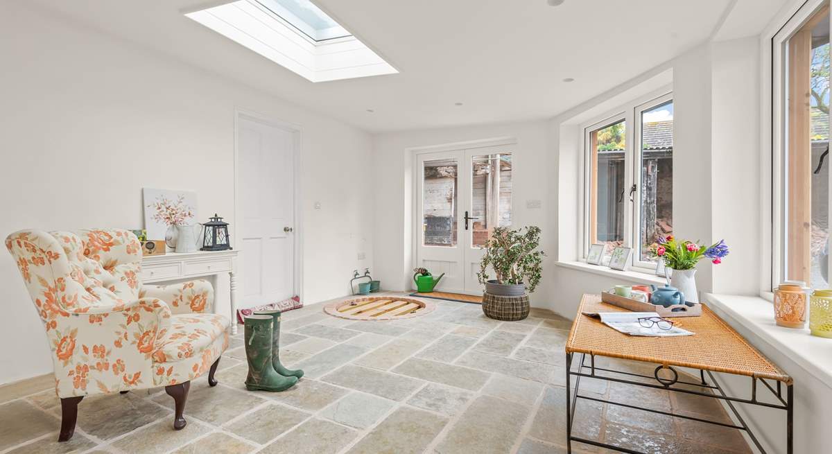 The conservatory is a light and airy space, perfect for enjoying a good book. It also opens up out into the courtyard, which is currently in its final finishing stages.