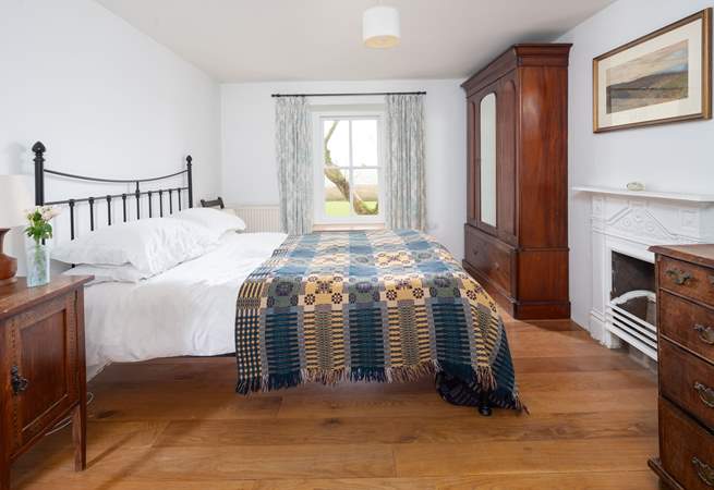 En suite bedroom with king-size bed and stunning views. 