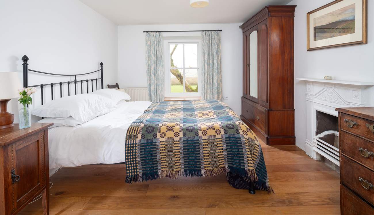 En suite bedroom with king-size bed and stunning views. 