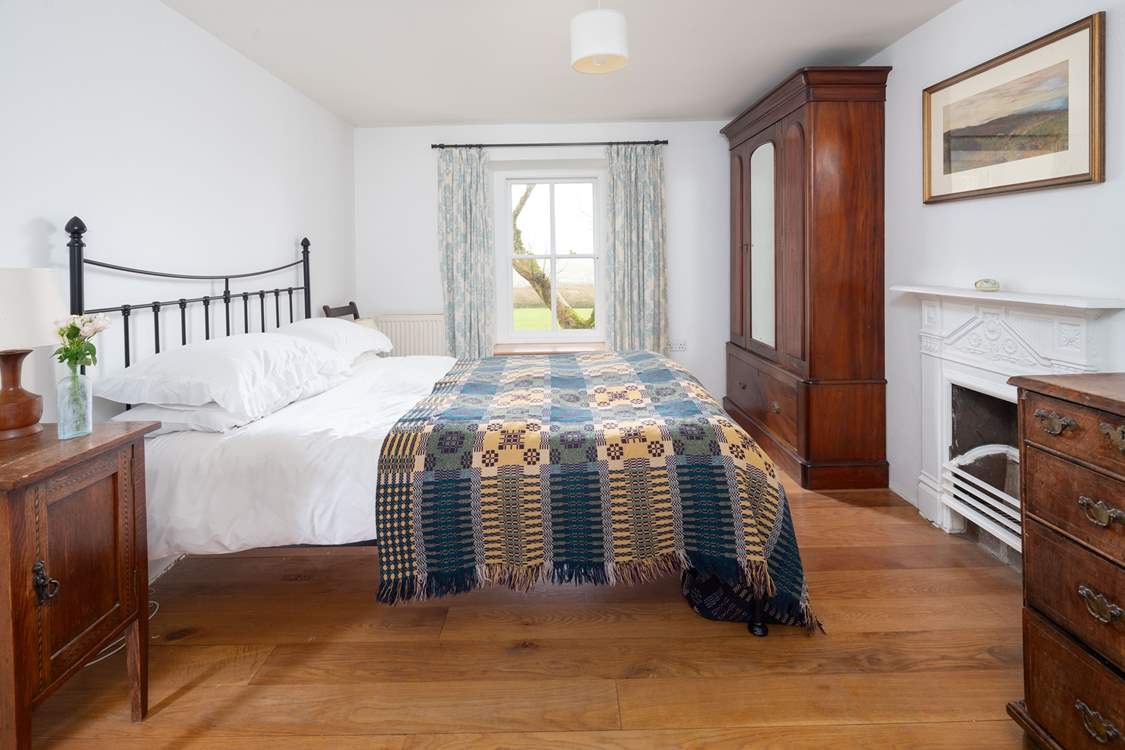 En suite bedroom with king-size bed and stunning views.