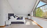 The main bedroom is a luxury suite with stunning views out towards Dartmoor and the estuary.  - Thumbnail Image