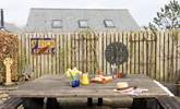 The owners have made this a fun entertaining area with a charcoal barbecue. - Thumbnail Image