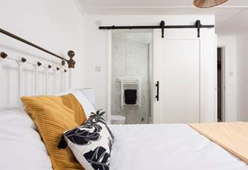 The sliding door to a sweet en suite shower-room in bedroom 3.