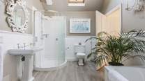 The gorgeous family bathroom has both a bath and a shower cubicle. 