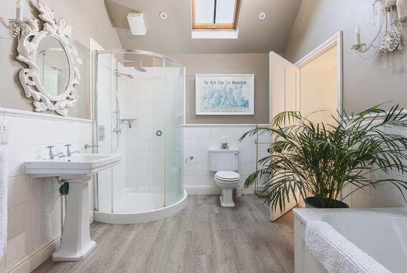 The gorgeous family bathroom has both a bath and a shower cubicle. 