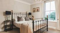 This gorgeous bedroom has a feature bedstead and king-size bed. 