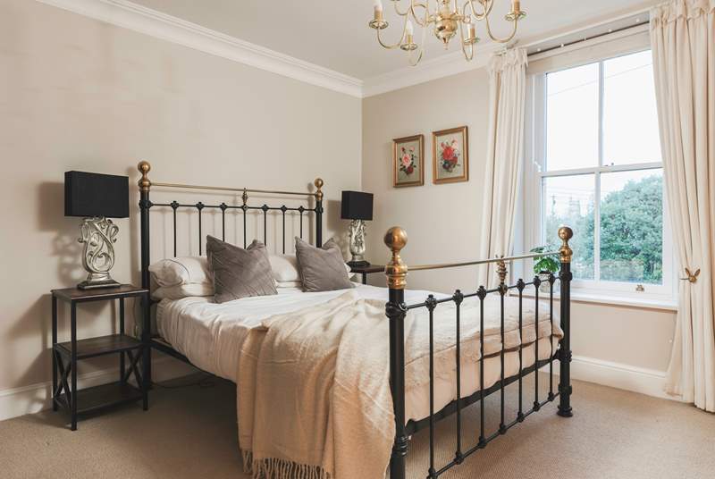 This gorgeous bedroom has a feature bedstead and king-size bed. 