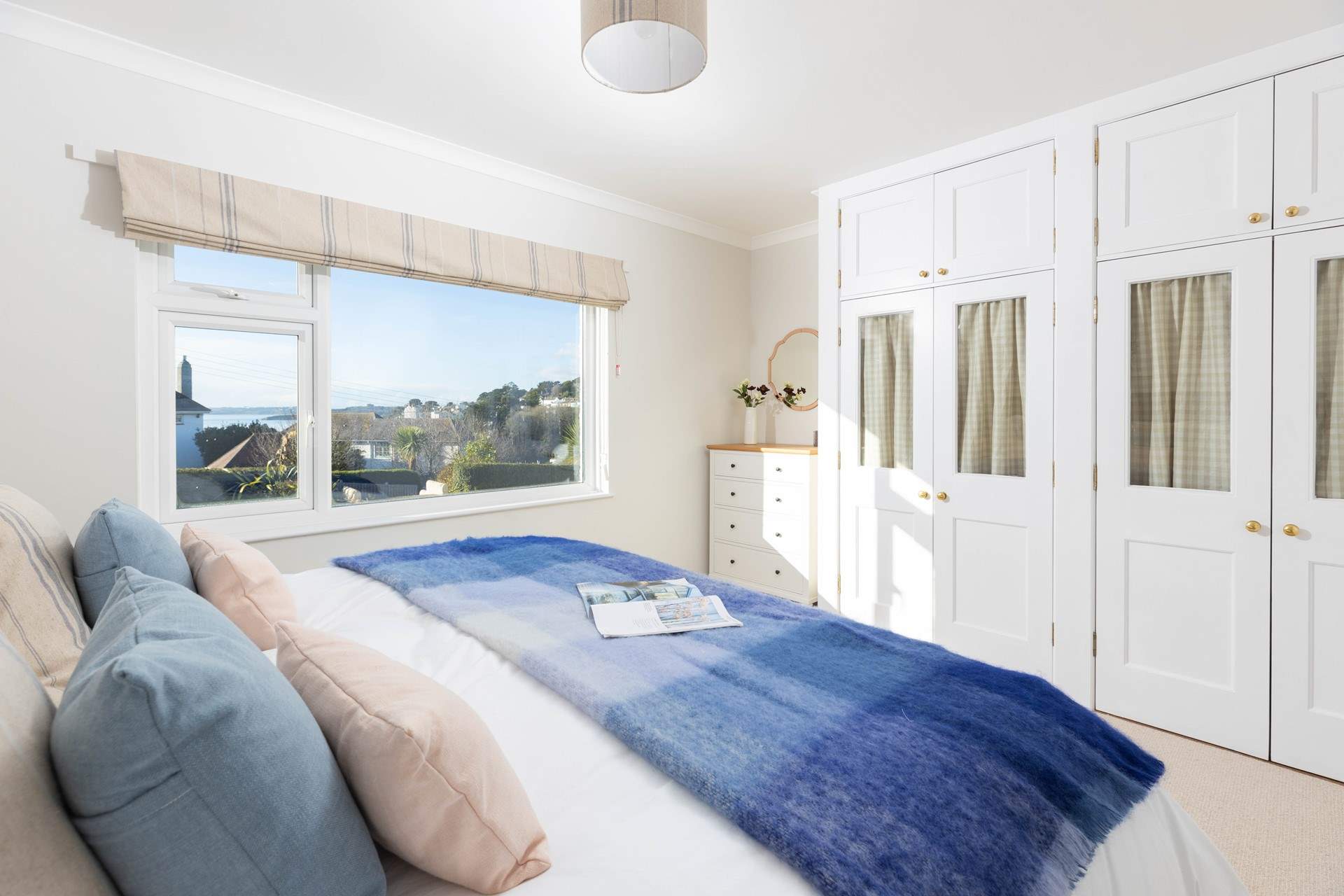 Spacious bedroom 1 with coastal views. 