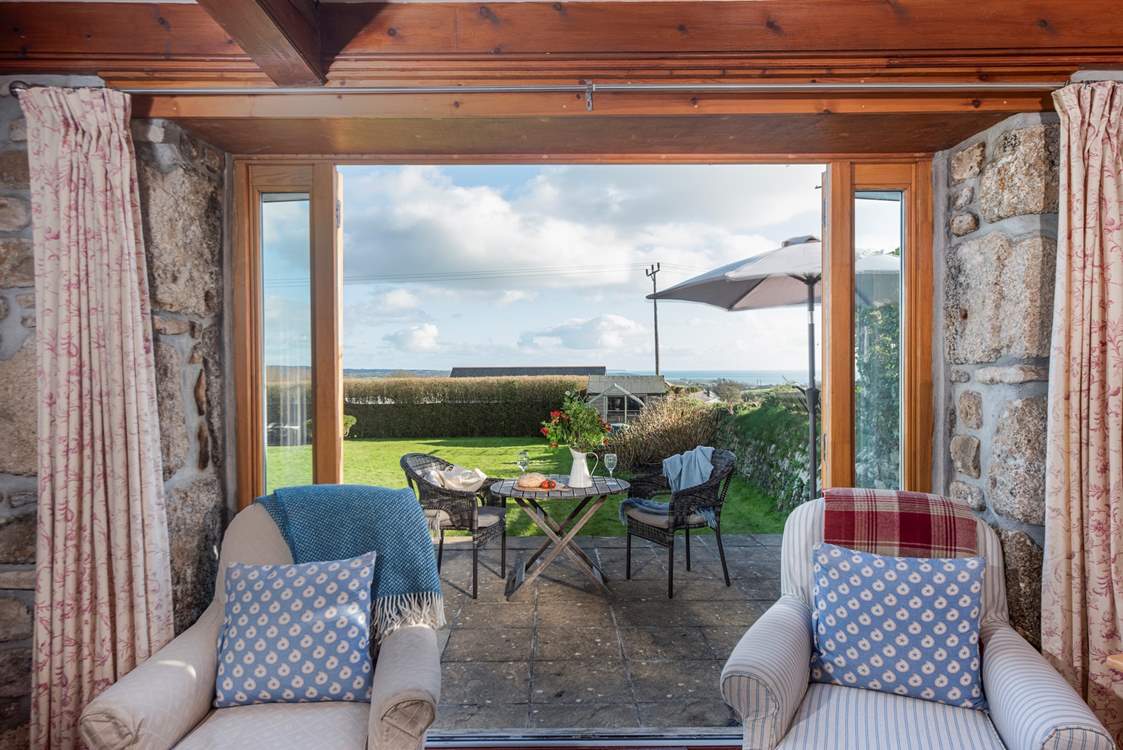 Step out of the French doors to find the patio and gorgeous lawn.