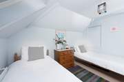 Bedroom 2 has two single beds. Please take care on the sloping ceilings.