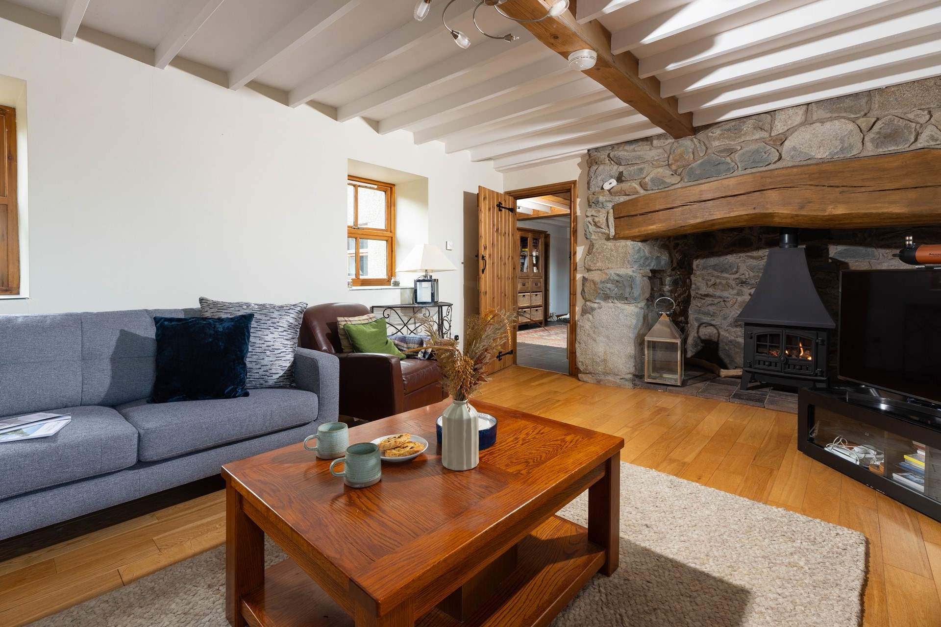 Gorgeous interiors throughout the cottage with a stunning inglenook fireplace housing a very realistic stove. The perfect place to relax after a day exploring this beautiful part of Wales.