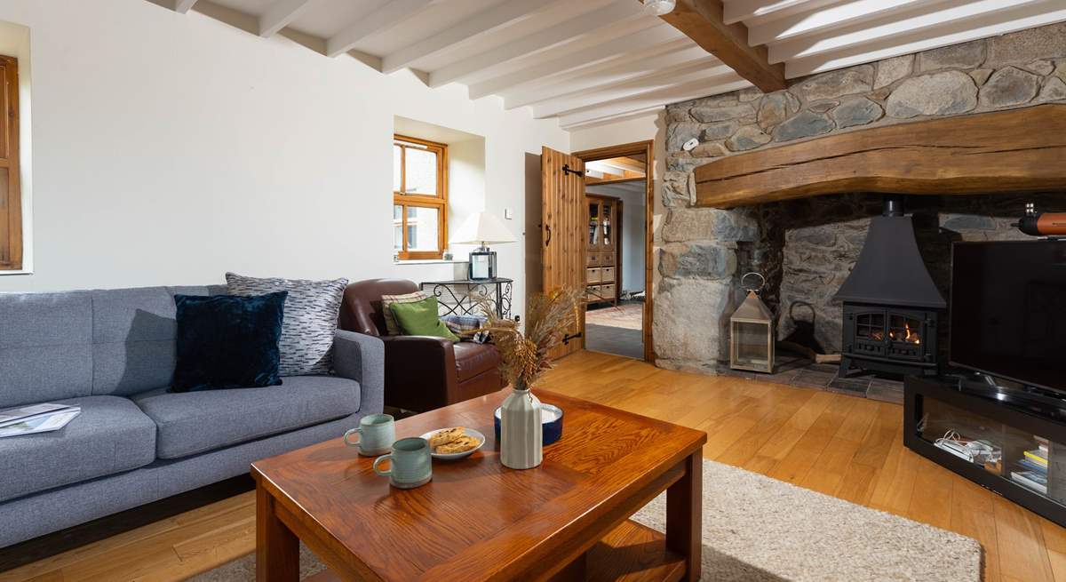 Gorgeous interiors throughout the cottage with a stunning inglenook fireplace housing a very realistic stove. The perfect place to relax after a day exploring this beautiful part of Wales.