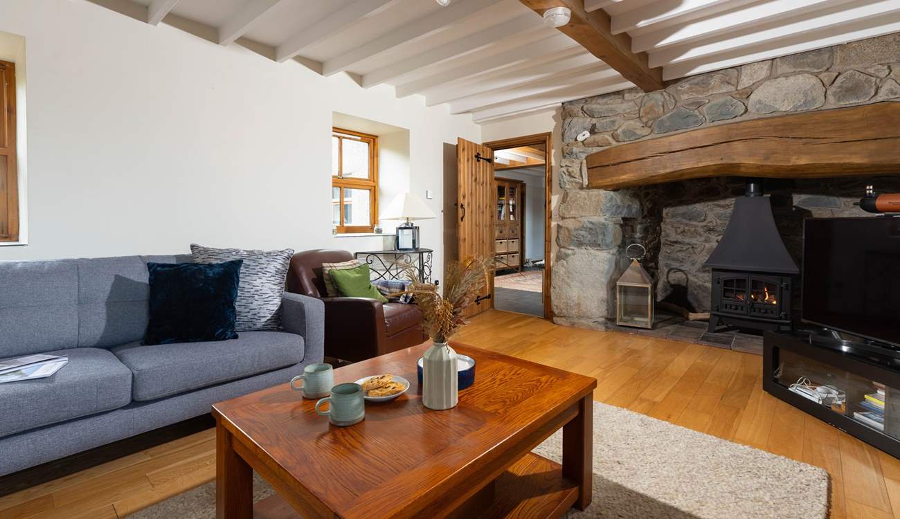 Gorgeous interiors throughout the cottage with a stunning inglenook fireplace housing a very realistic stove. The perfect place to relax after a day exploring this beautiful part of Wales.