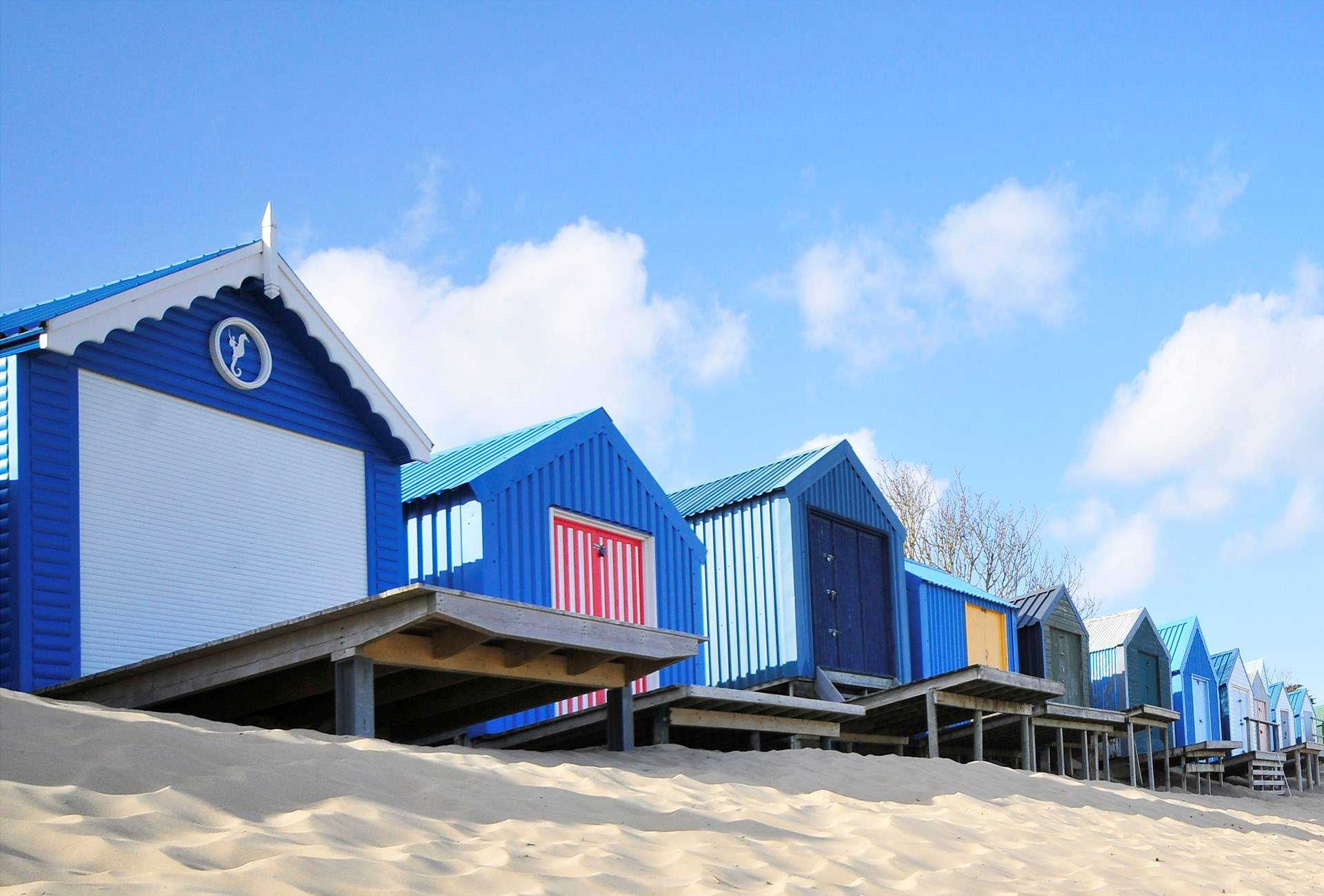 Pretty beach huts and golden sand at Abersoch. 
