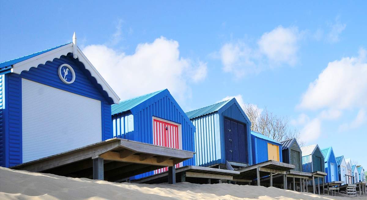 Pretty beach huts and golden sand at Abersoch. 