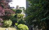 Looking up at castellated Place House from the square by the church. - Thumbnail Image