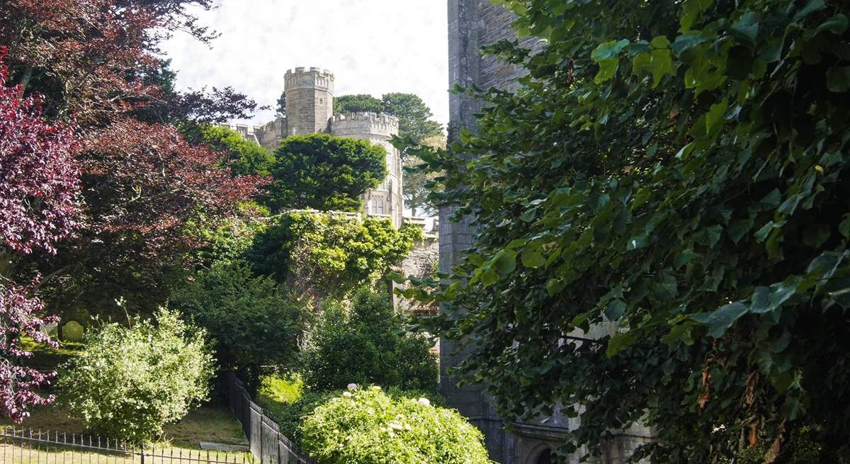 Looking up at castellated Place House from the square by the church.