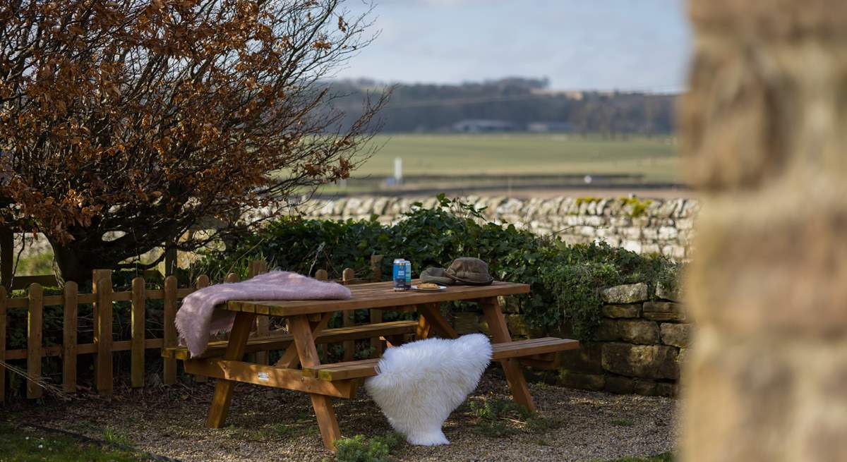 Al fresco dining with a view over the fields towards the sea.