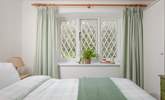 A charming room, dressed in soothing shades for a blissful night's sleep. - Thumbnail Image