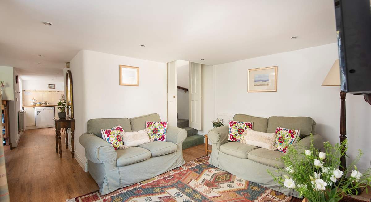 The cottage sitting-room is super cosy with little doors closing off the stairs.