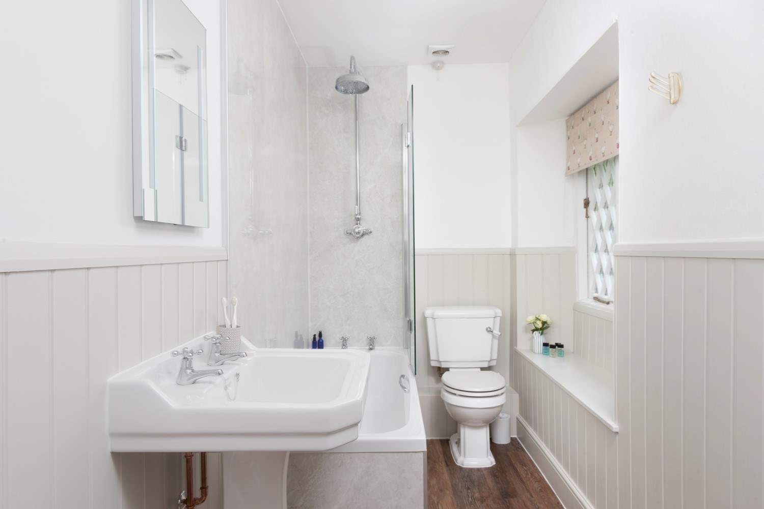 The family bathroom offers a fitted shower above the bath.