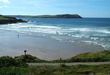 The waves at Polzeath attract surfers from far and wide.