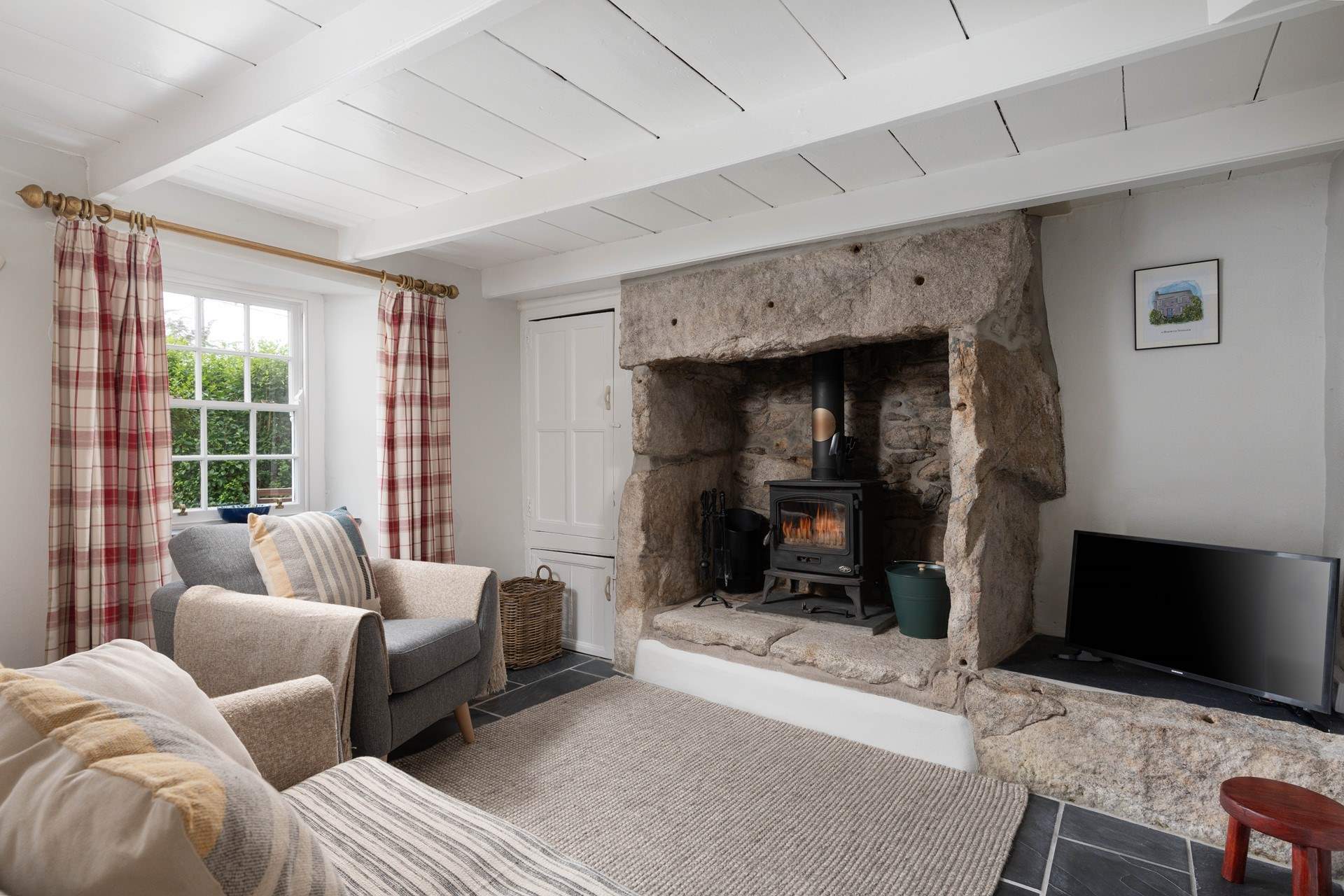 A beautiful granite fireplace housing the warming wood-burner.