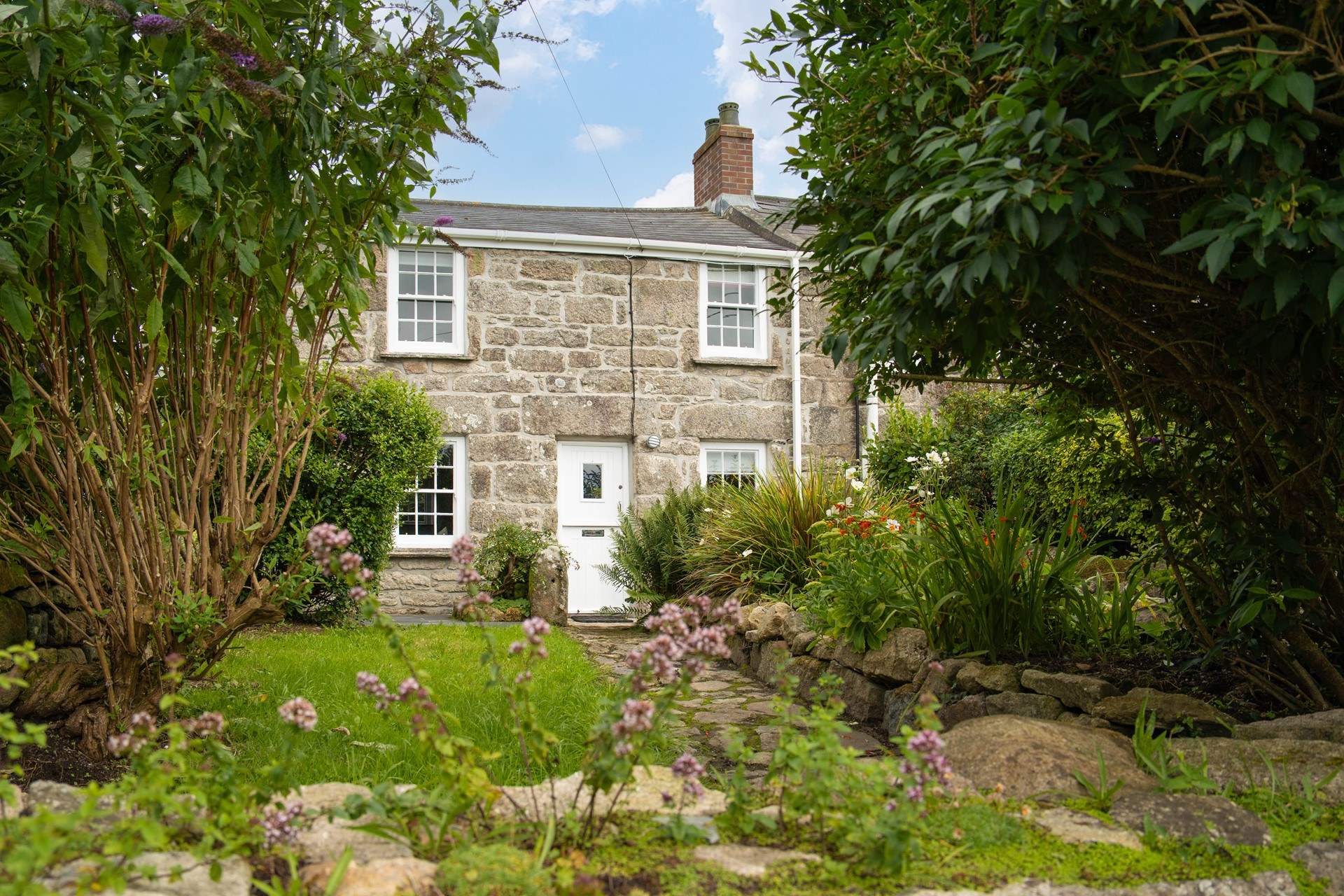 Welcome to Tinners Cottage, follow the pretty pathway leading up to the stable door.