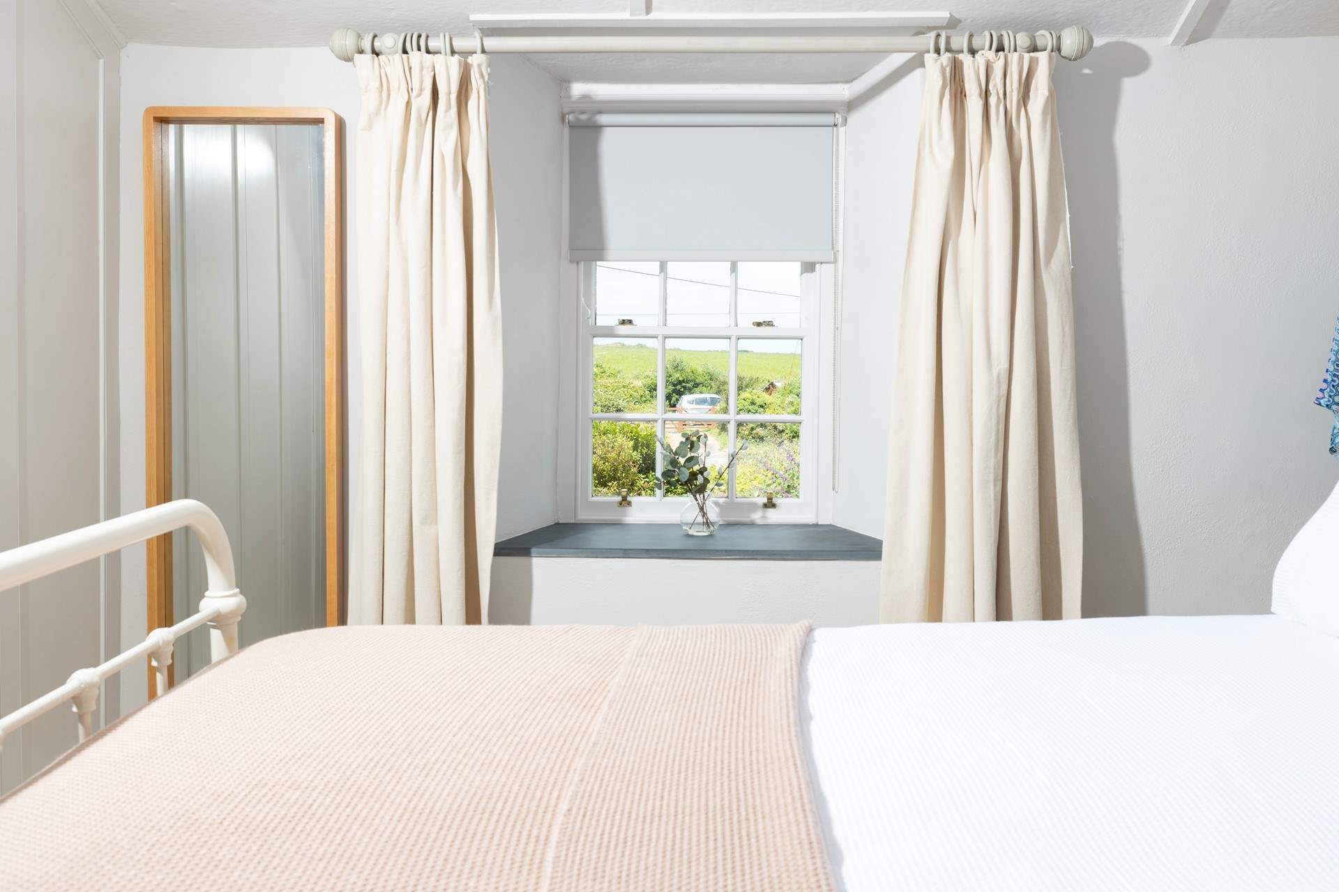 The bedroom is decorated in calming neutral hues. 