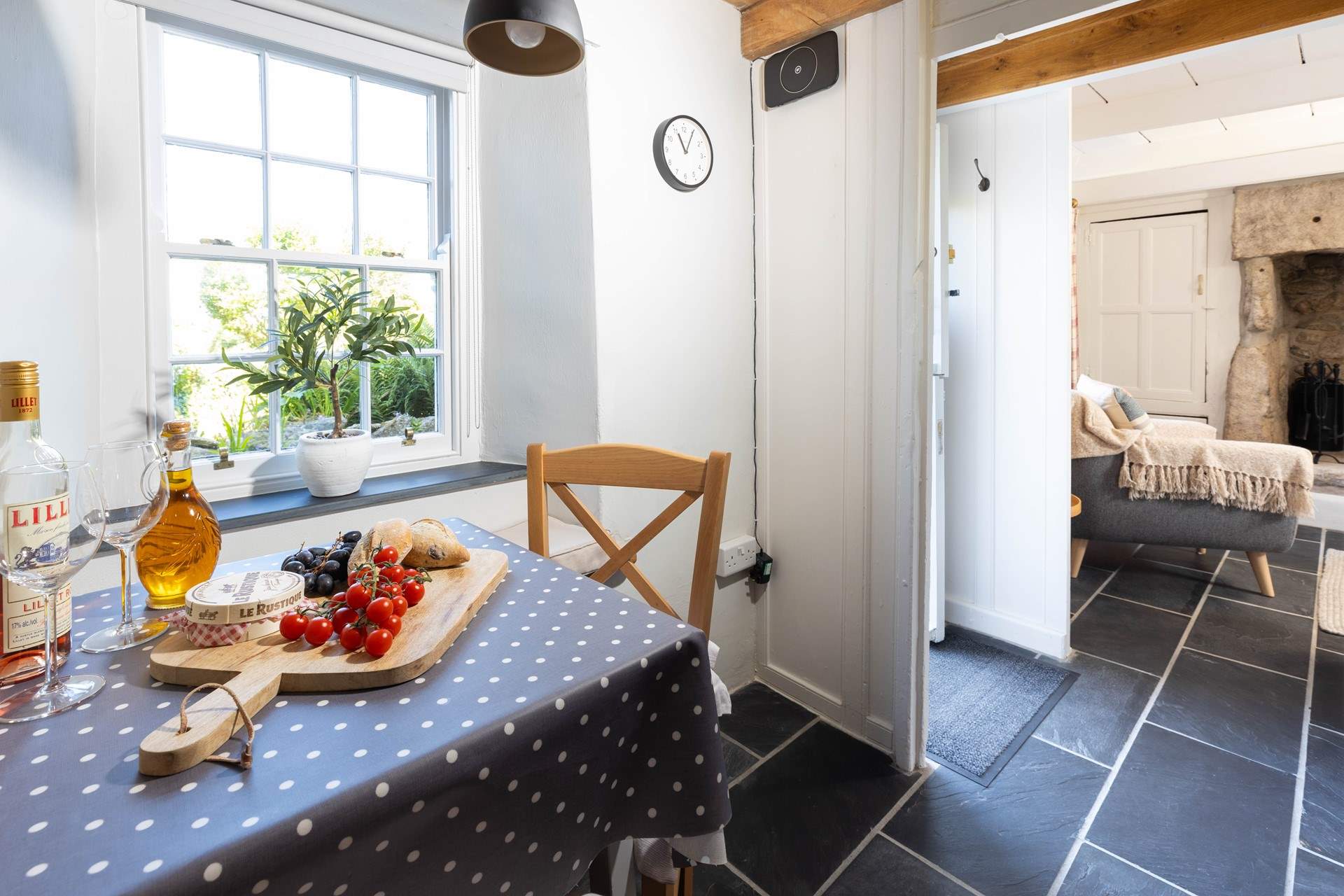 Gather around the dining-table. You can take your pick from the window seat or chairs. 