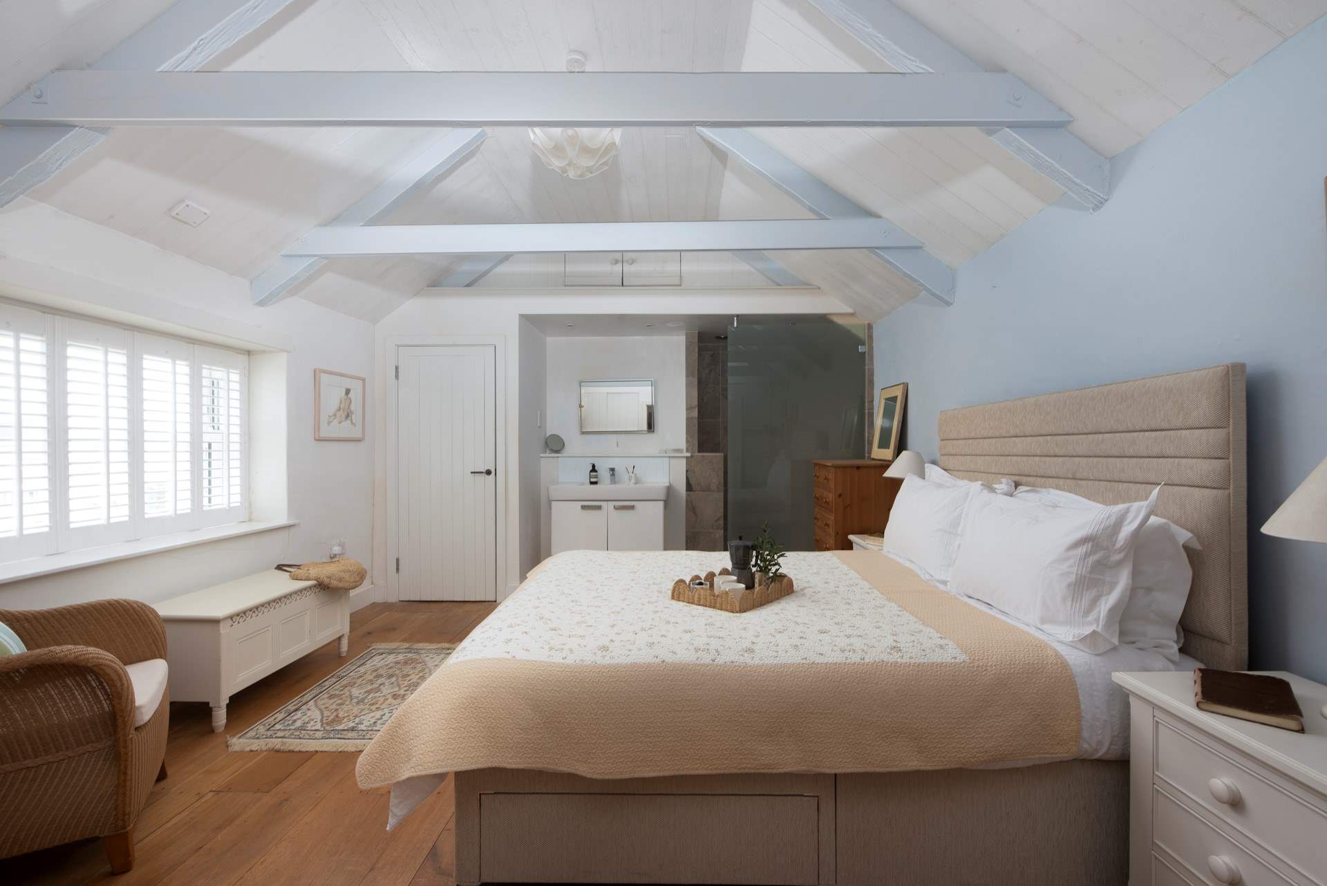 The shower is located behind the glazed glass door. 
