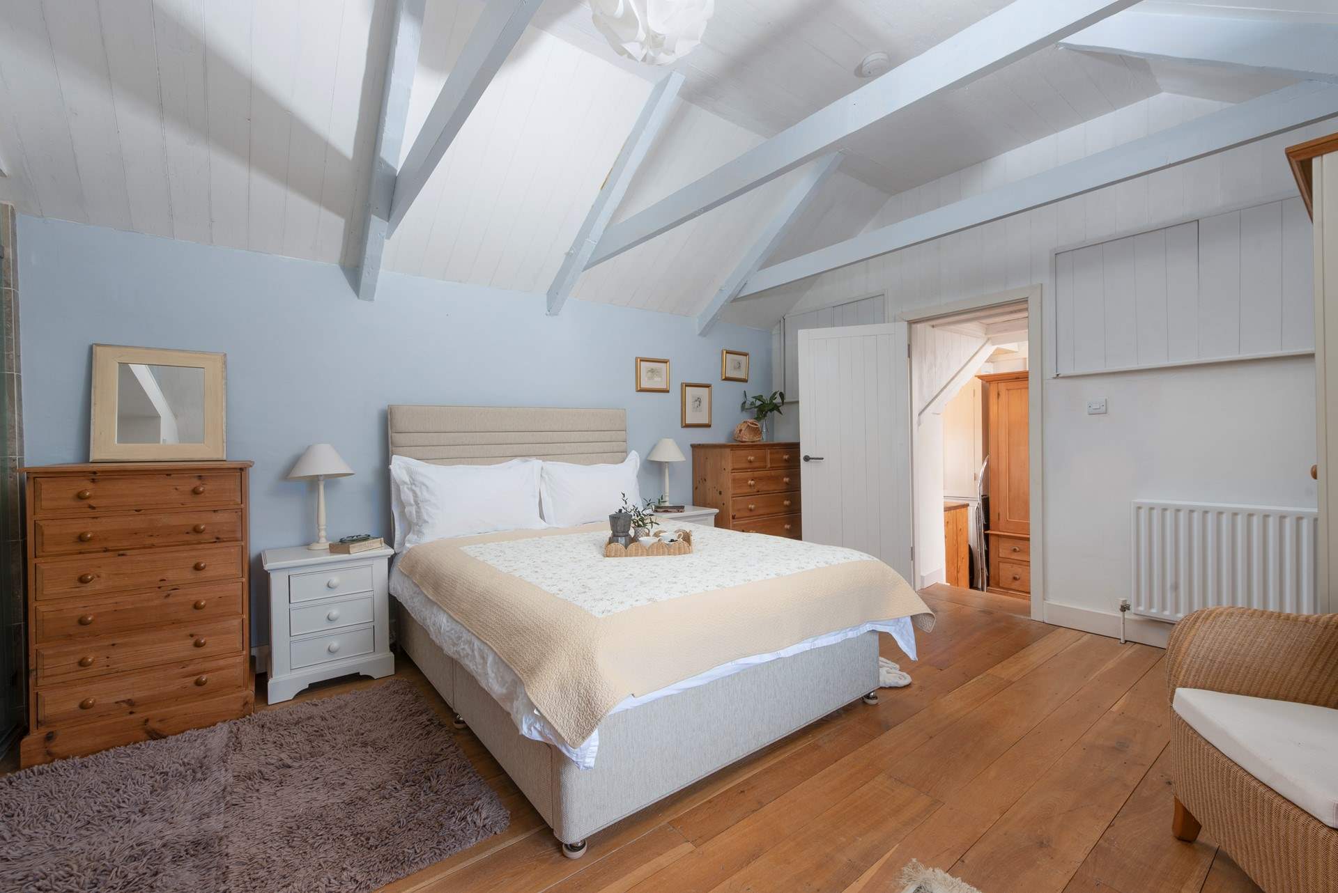 Up on the first floor, there are two further steps leading into the main bedroom with en suite shower-room.