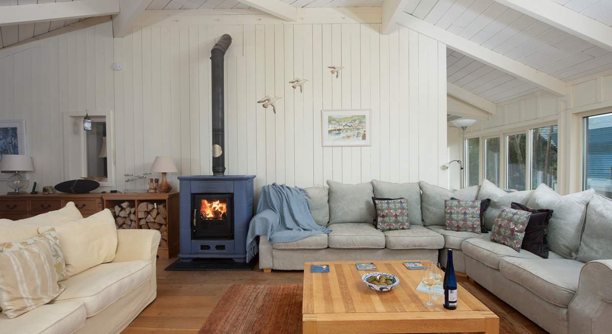 The sitting-room to the front of the house is magnificent with a fabulous larger than life wood-burner and plenty of sofa seating.