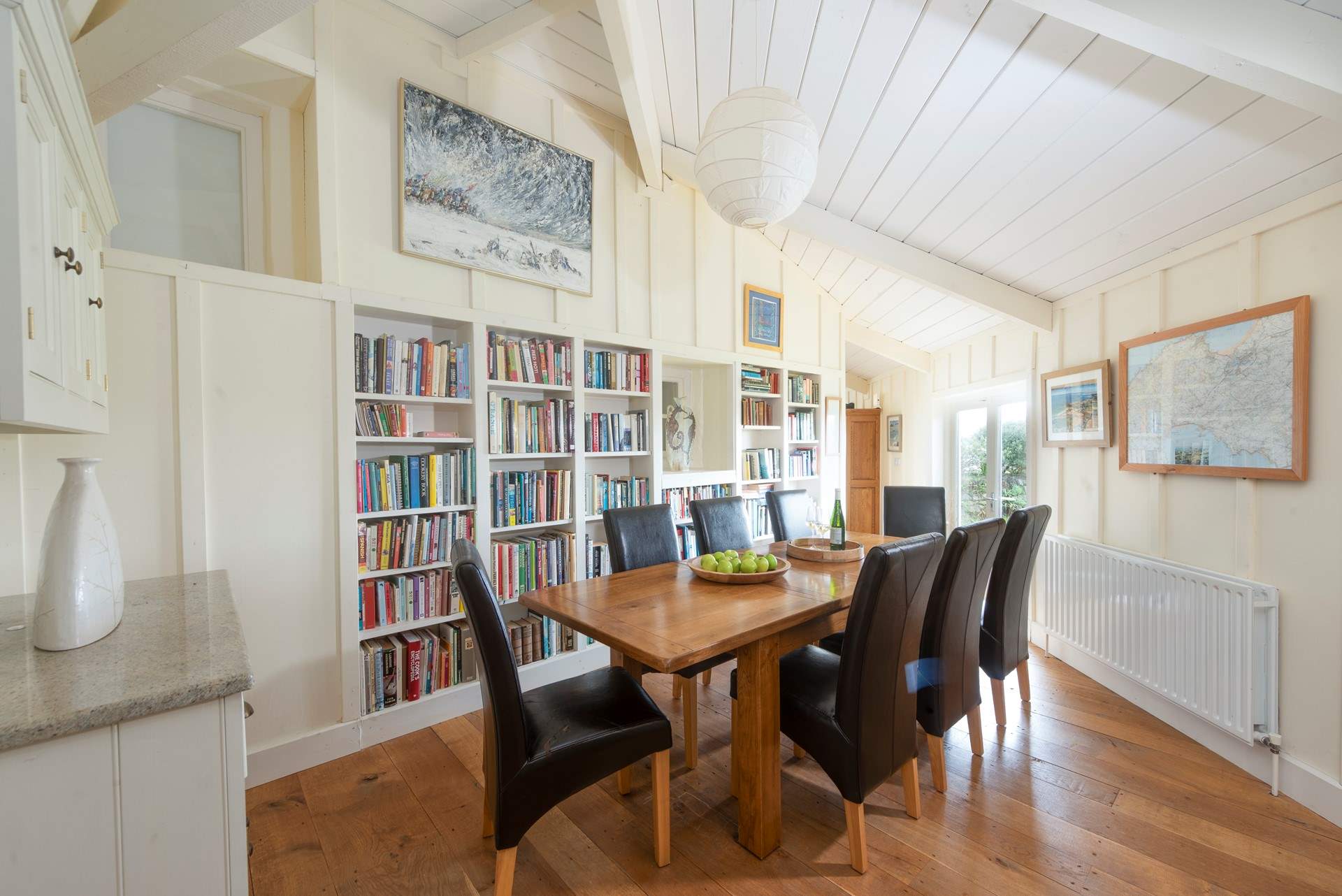 Next to the kitchen (down two steps) lies a super handy utility cupboard with a washing machine/drier. You will also find the more formal dining-table in this room. 