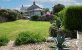 From the garden looking back up to the hot tub and outdoor dining-area. - Thumbnail Image