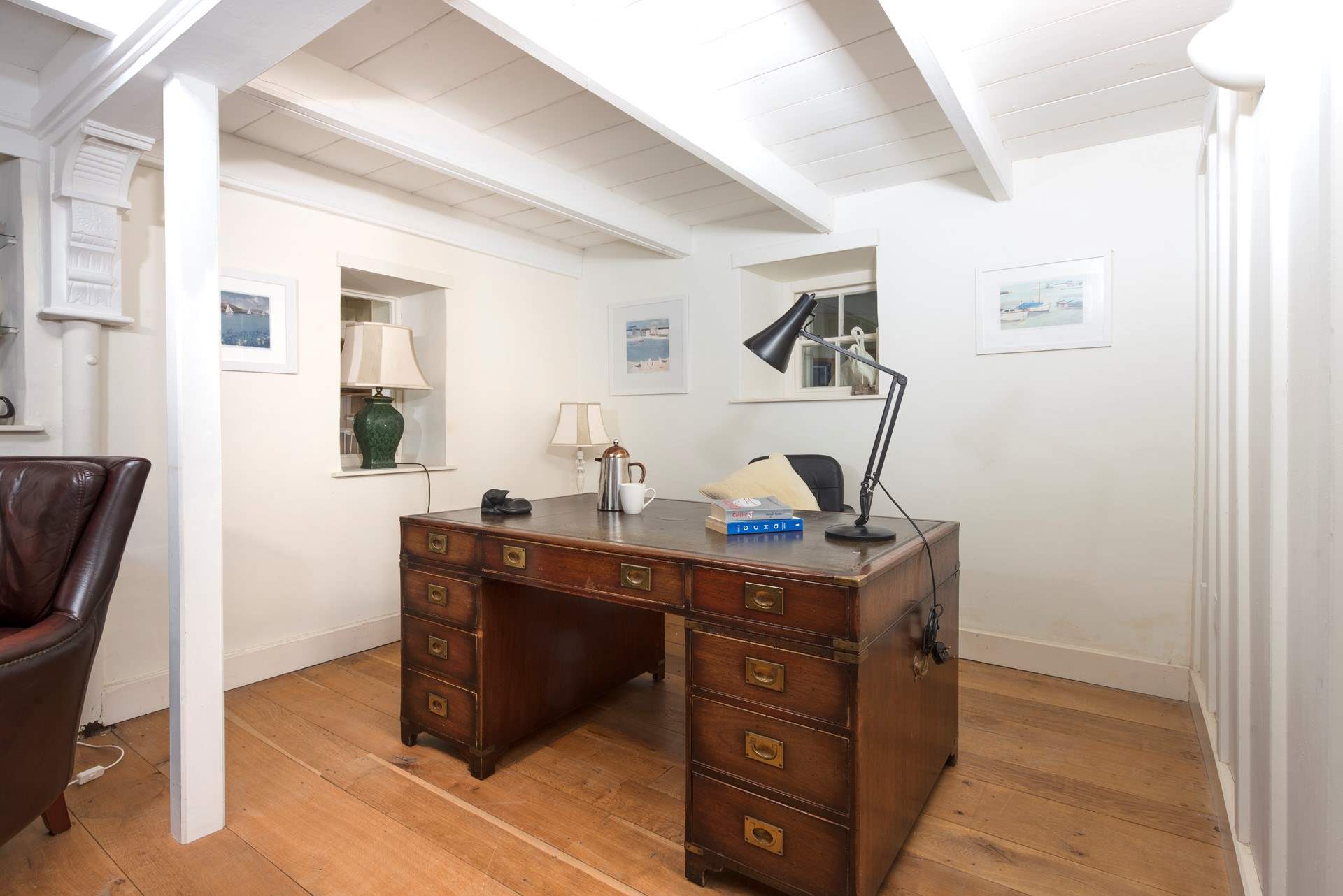 Go 'old school' and write a few postcards on this beautiful wooden leather topped desk.