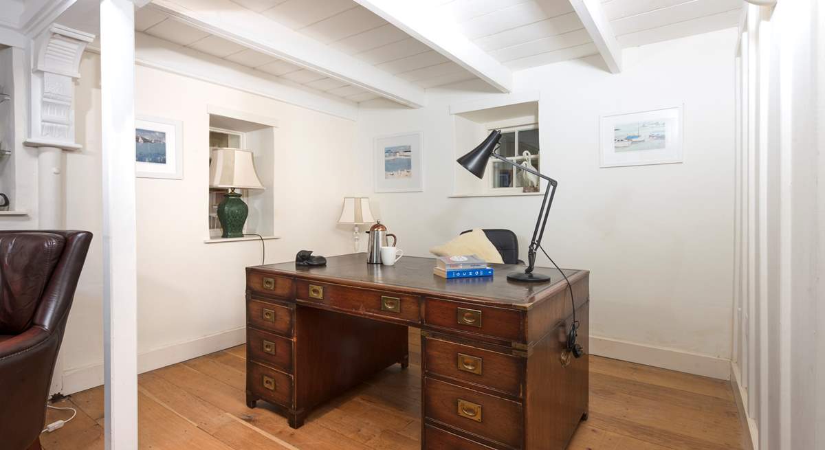 Go 'old school' and write a few postcards on this beautiful wooden leather topped desk.