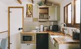 The stylish kitchenette is well-equipped. - Thumbnail Image