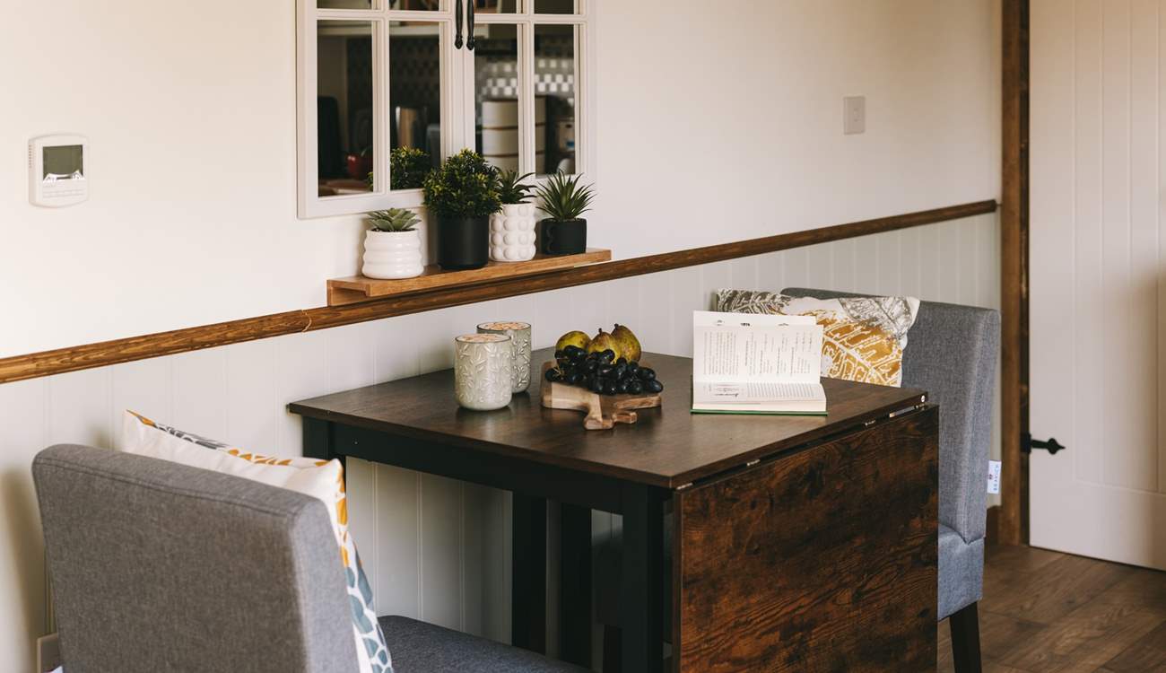 Take a pew and enjoy a morning brew with a view out of the hut doors.