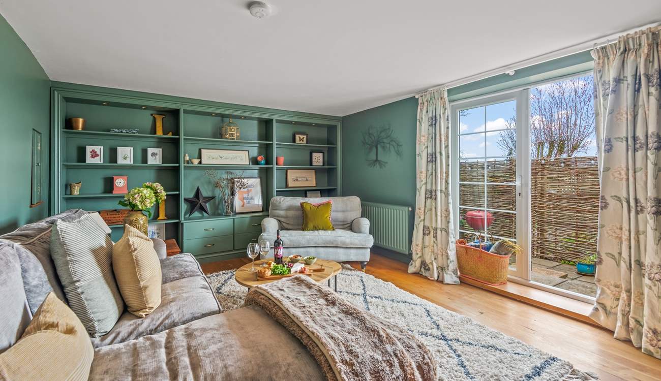 The beautiful sitting-room opens up into your enclosed patio-area.