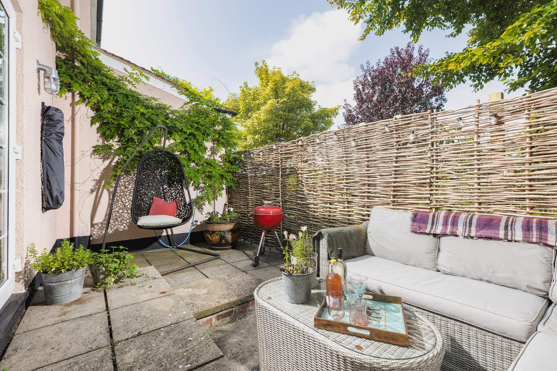 Your outside space offers a beautiful spot to sit back and relax in, especially in that fabulous swinging chair.