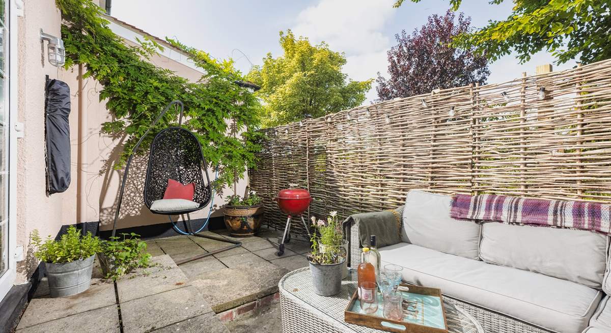 Your outside space offers a beautiful spot to sit back and relax in, especially in that fabulous swinging chair.