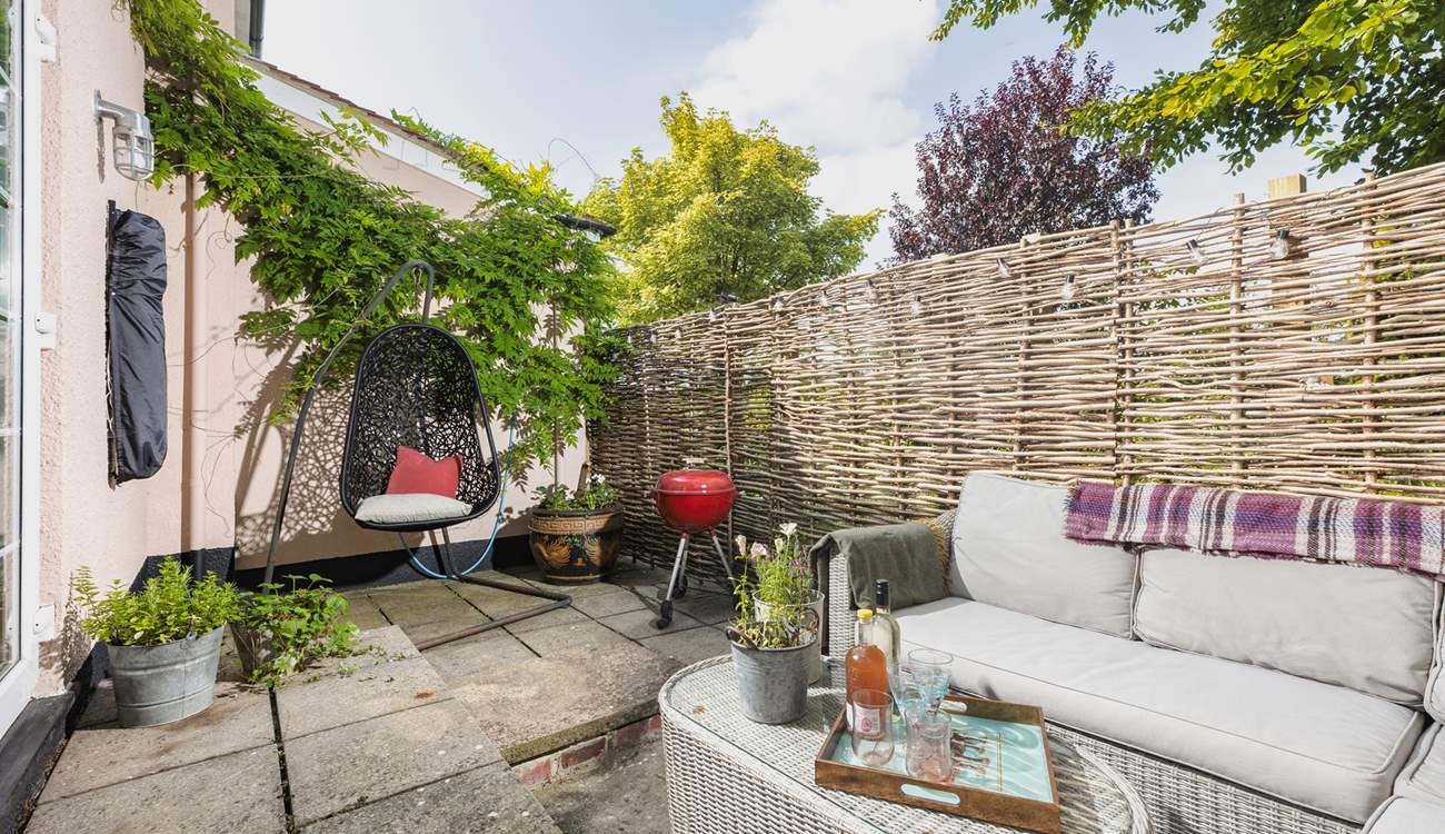 Your outside space offers a beautiful spot to sit back and relax in, especially in that fabulous swinging chair.