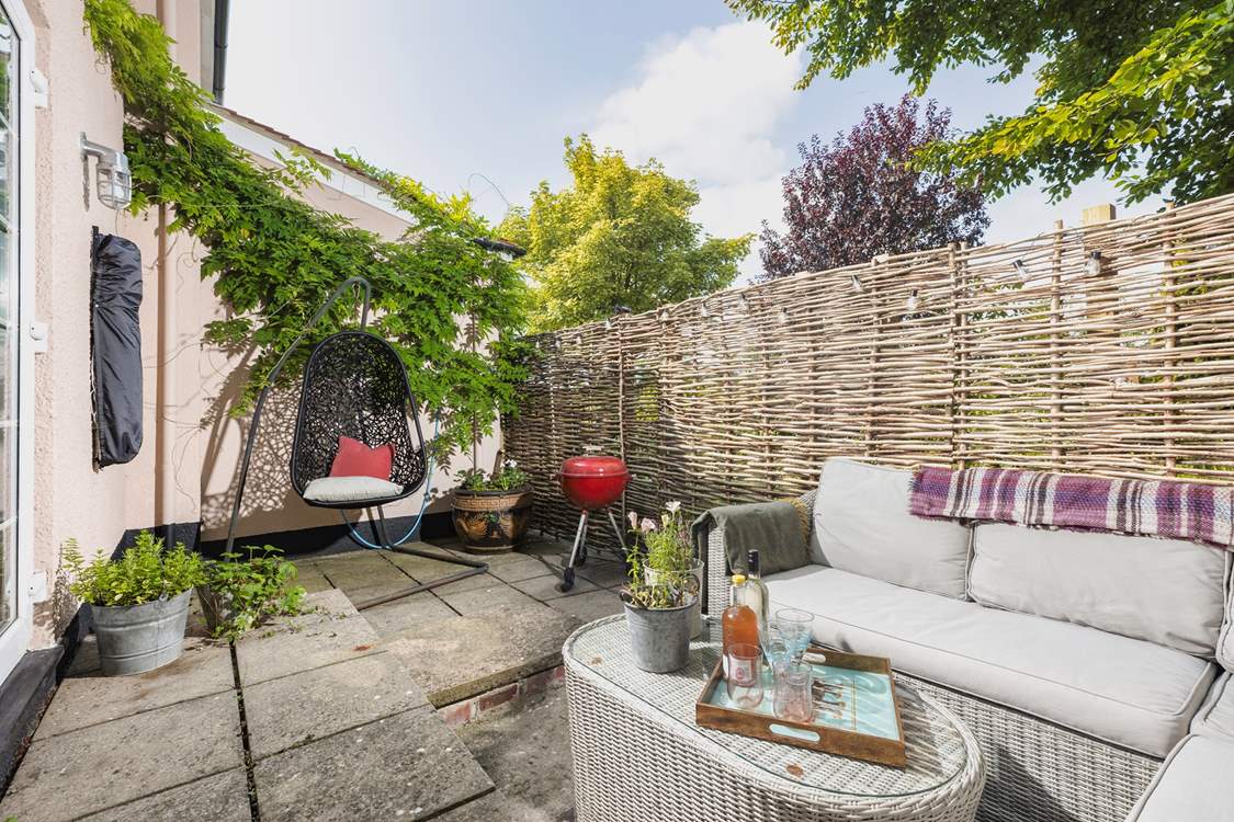 Your outside space offers a beautiful spot to sit back and relax in, especially in that fabulous swinging chair.