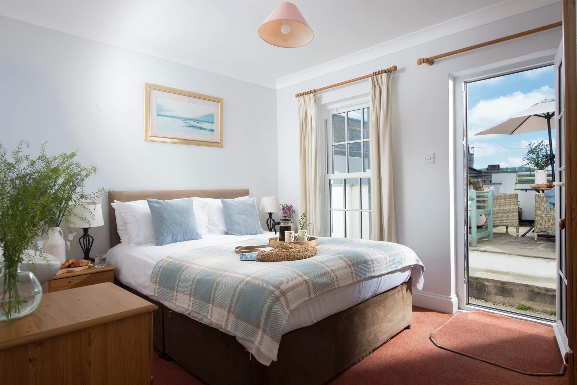 Bedroom 1 has a king-size bed and access to the outside patio area.