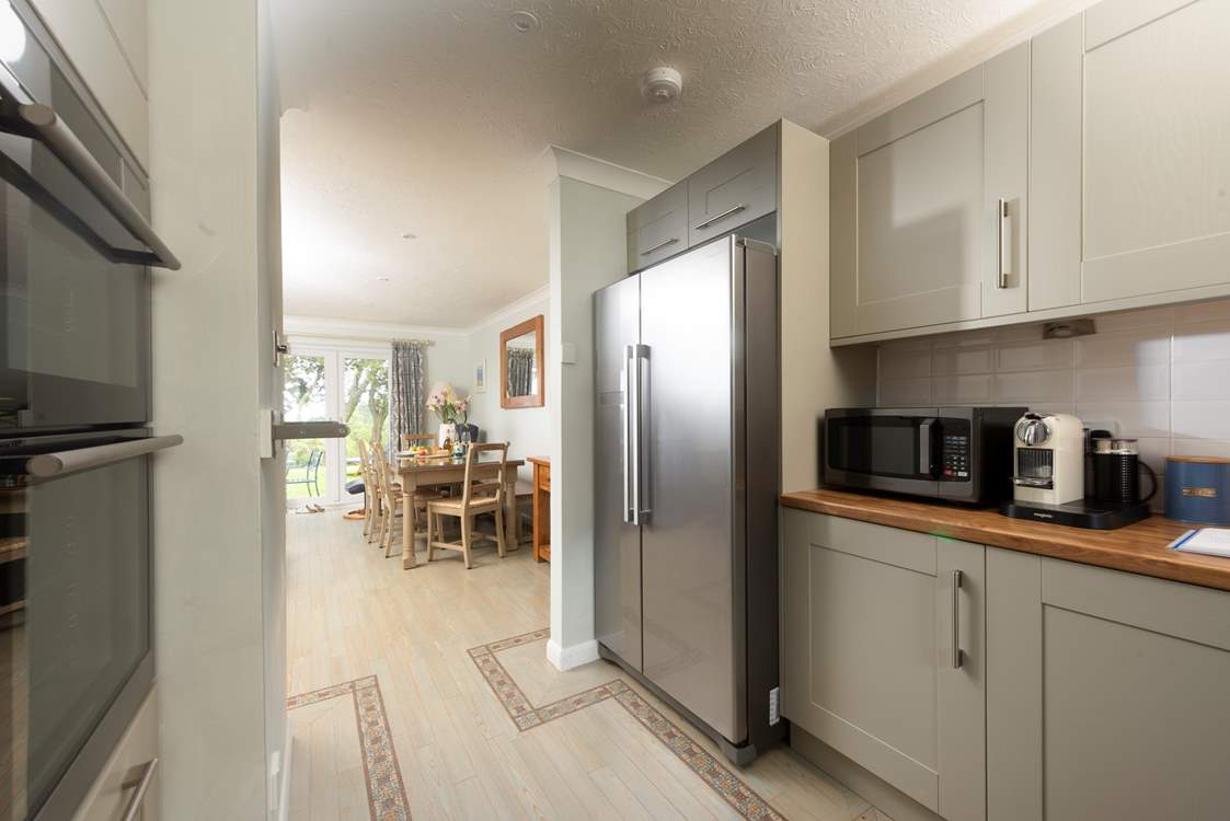 The kitchen leads to the open plan living space.