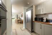 The kitchen leads to the open plan living space.